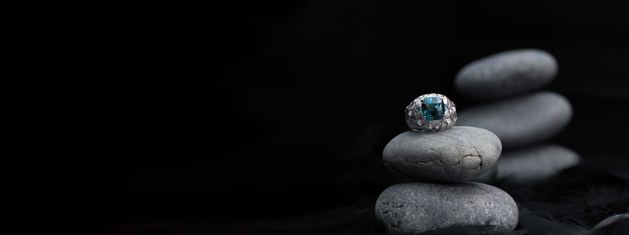 Gemstone ring on dark stones